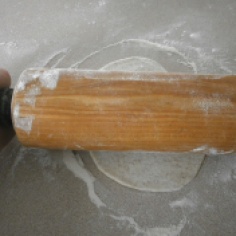 Using plenty of flour on the counter and on the rolling pin will prevent sticking. Roll at different angles and rotate the dough so that the shape becomes round instead of oval.