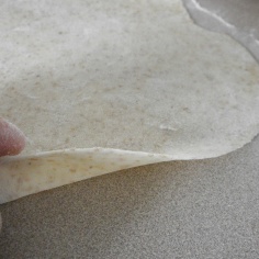 After rolling the dough at different angles, the raw tortilla will be smooth and thin.